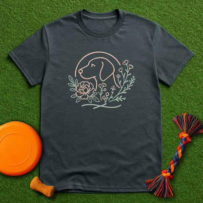 Dark gray t-shirt with dog and floral design on a green surface with toys.