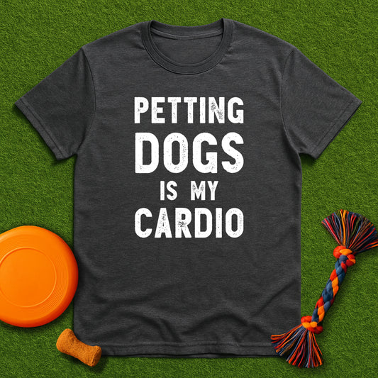 Dark gray t-shirt with 'Petting dogs is my cardio' text on a green grass background with dog toys.